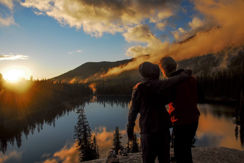 Students overlooking a scenic lake on trip